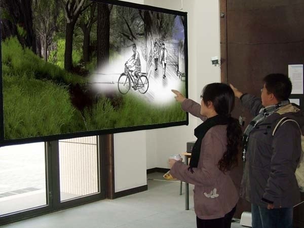 Visitors pointing at the Periphery installation revealing the artist-drawn past