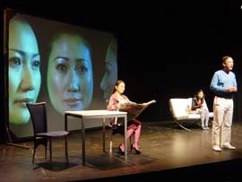Ultimate Commodity on stage at the Esplanade Theater with projected faces